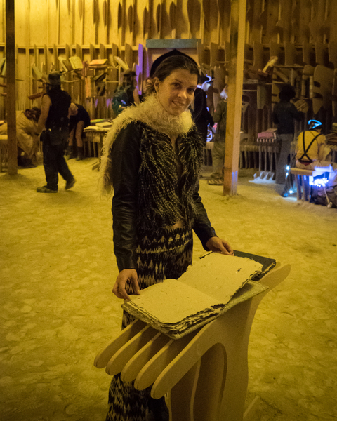 A burner reading one of the handmade books.